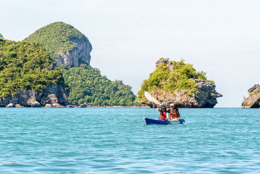 Two women are mother and daughter. Travel by boat with a kayak around island enjoy view the beautiful natural landscape of the blue sea at summer, Mu Ko Ang Thong National Park, Surat Thani, Thailand