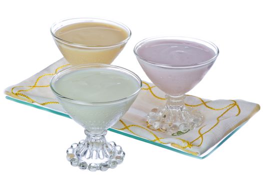 three cups of yogurt in different flavors