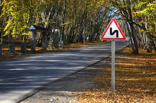 Sign at the forestroad.A warning of asteep turn.