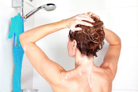 Closeup shot of woman washing her hair in a shower