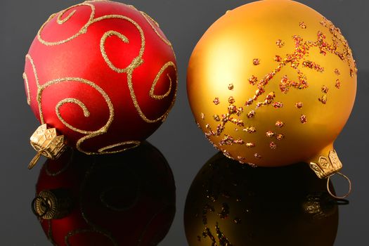 Red and gold christmas balls on black background