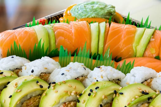 Sushi Roll Platter with Raw Salmon Avocado Cream Cheese Platter Closeup Macro