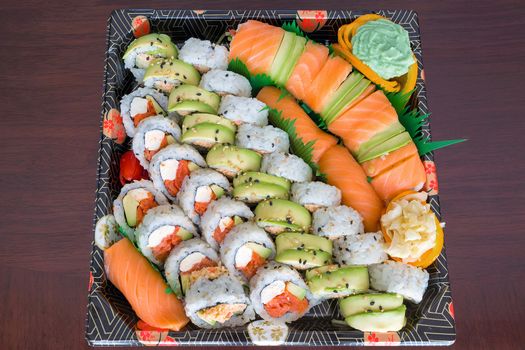 Sushi Party Platter with fresh raw smoked salmon California Caterpillar rolls Nigiri Wasabi ginger