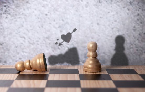 Love heart cupid arrow shadow aiming at fallen chess pawn