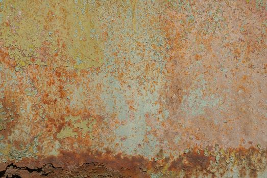 fragment of a rusty iron surface covered with old paint, which has long been under the influence of different climatic conditions