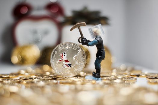 Europe leaving. Silver brexit coin and miner. British map.