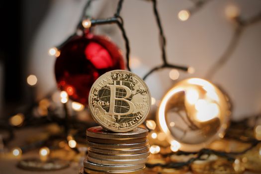 Crypto currency physical gold bitcoin coin in christmas scene near fire ball.