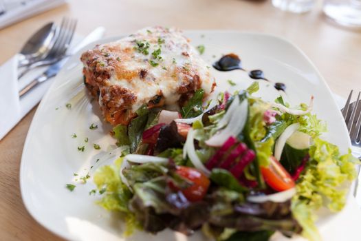 Authentic Italian Meat Lasagna with fresh salad.