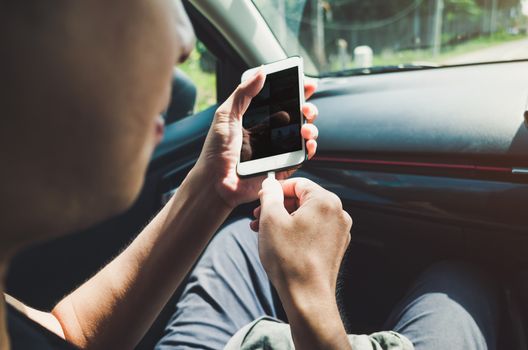 Man using phone in the car.