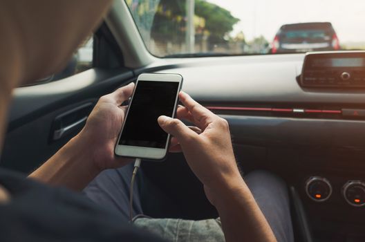 Man using phone in the car.