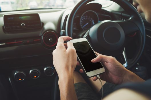 Man using phone in the car.