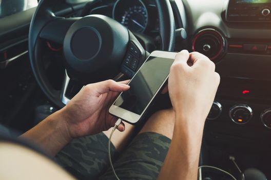 Man using phone in the car.