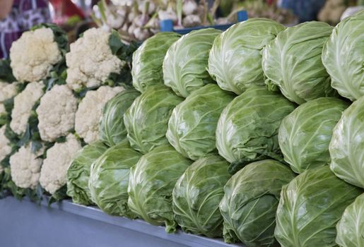 Fresh cabbages and cauliflower for sale at a market
