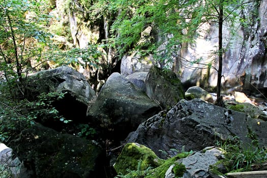 Natural blockage by the boulders to the gorge of mountain river.