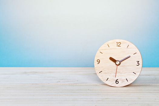 Business, savings time, deadline or delay concept : wooden alarm clock on white background