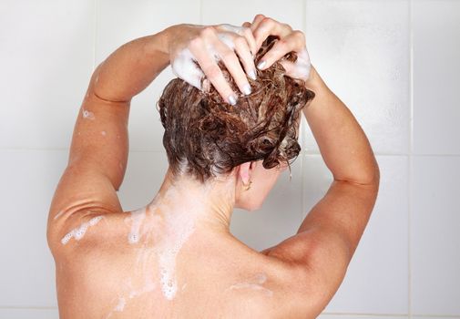 Closeup shot of woman washing her hair in a shower