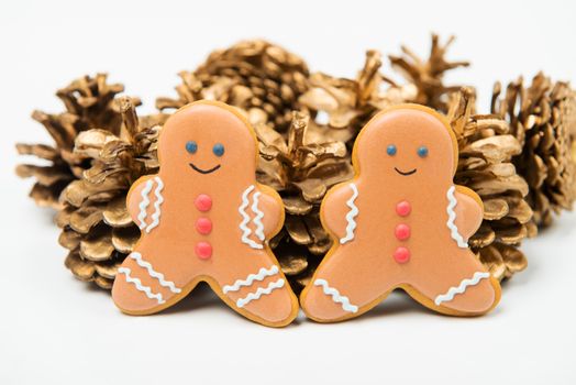 Christmas concept. Christmas gingerbread with golden pine cones on white background