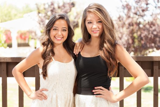 Two Mixed Race Girlfriends Pose for Portrait Outdoors