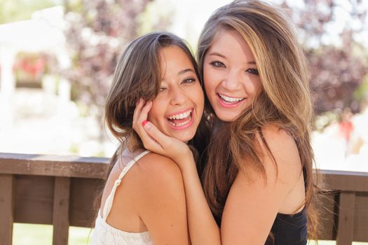 Two Mixed Race Girlfriends Pose for Portrait Outdoors