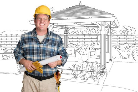 Male Contractor With House Plans Wearing Hard Hat In Front of Custom Pergola Patio Covering Drawing