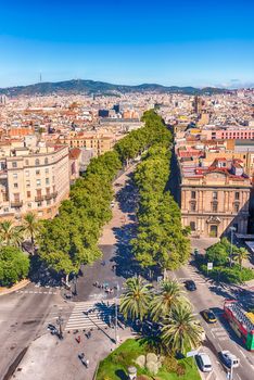 Scenic aerial view of La Rambla, tree-lined pedestrian mall and popular tourist sight in Barcelona, Catalonia, Spain