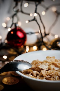 Delicious and fresh corn flakes in white bowl. Christmas food concept.