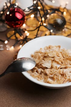 Delicious and fresh corn flakes in white bowl. Christmas food concept.