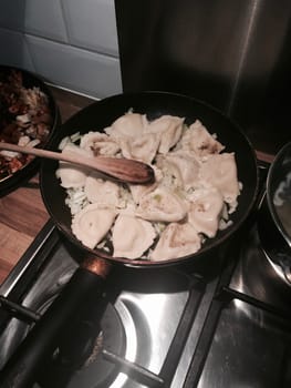 Vegetarian russian dumplings on the pan in the kitchen. Food concept.