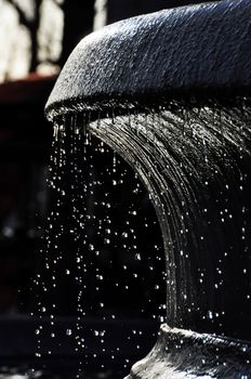 Backlit fountain in Paris, France. High shutter speed to freeze the droplets.