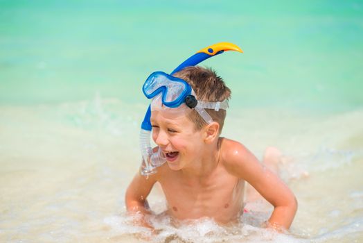 happy boy in a snorkeling mask in the sea