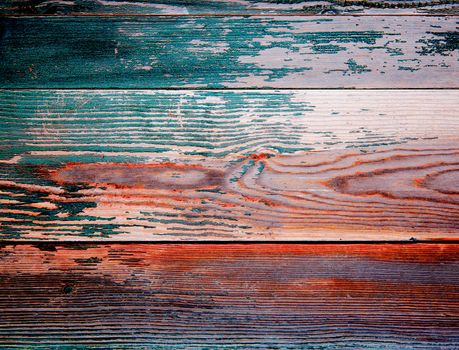 Background of Red, Beige and Dark Green Peeling Old Wooden Board closeup