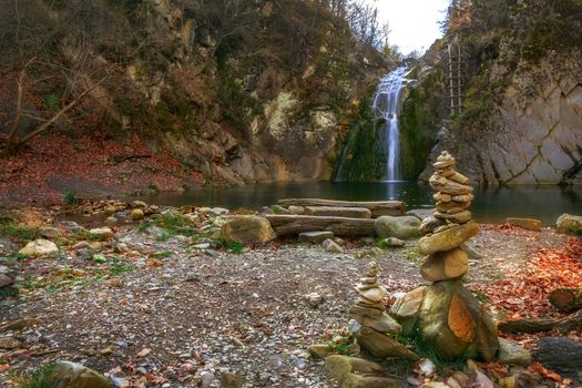Beauty autumn view on a waterfall "jump" near the village Kaleytsa near Troyan and several zen stone  