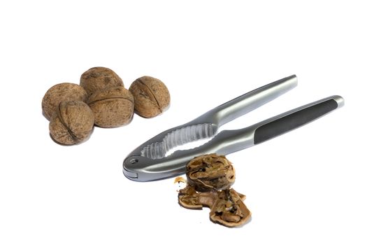 Group of walnuts and broken walnuts with a Nutcracker, isolated  on white background