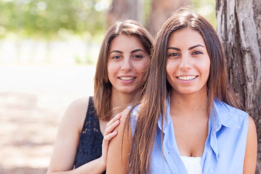 Two Beautiful Ethnic Twin Sisters Portrait Outdoors.