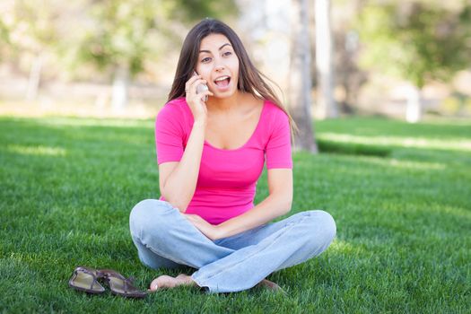 Beautiful Young Ethnic Woman Talking on Her Smartphone Outside.