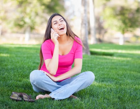 Beautiful Young Ethnic Woman Talking on Her Smartphone Outside.