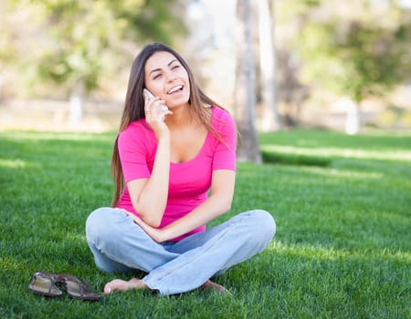 Beautiful Young Ethnic Woman Talking on Her Smartphone Outside.