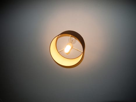 bedroom ceiling light turned on electricity white bright; essex; england; uk