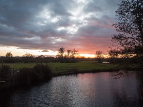 beautiful sunset dramatic sky country dedham river water red autumn; essex; england; uk