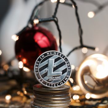 Digital currency physical silver metal litecoin coin. Christmas concept.