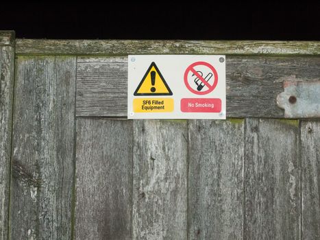 outside no smoking sign warning yellow triangle; essex; england; uk