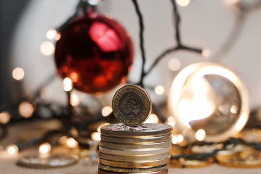 British currency. One pound coin in christmas lights concept.