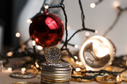 British currency. One pound coin in christmas lights concept.