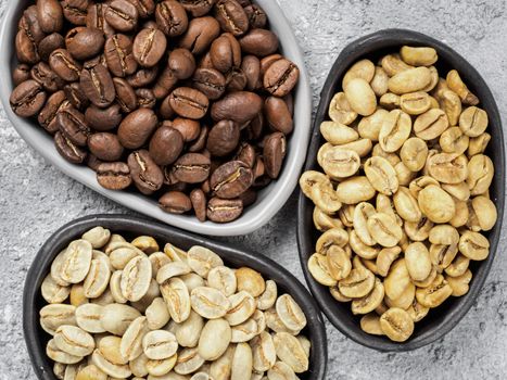 Trendy plates with white, green and brown coffee bean on gray concrete background. Top view or flat lay. Image with natural colors