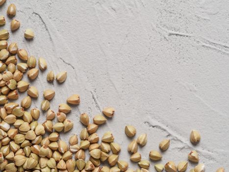 Raw green buckwheat on gray concrete background Healthy food and diet concept. Top view or flat lay