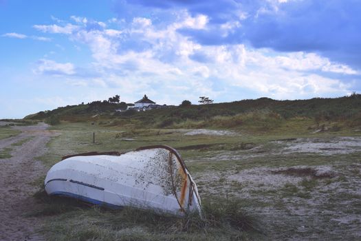 upturned fishing boat on heath near shore