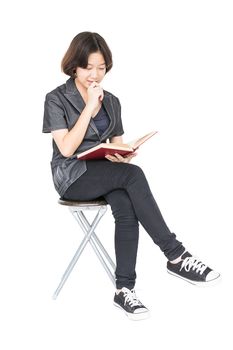 Asian woman reading a book sitting on chair Isolated on white background