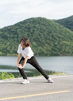 Fitness and lifestyle concept - Young asian woman short hair doing exercising outdoor