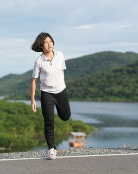 Fitness and lifestyle concept - Young asian woman short hair doing exercising outdoor