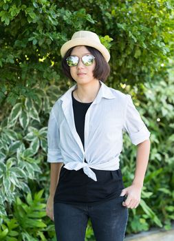 Beautiful and young women with short hair wearing hat in park